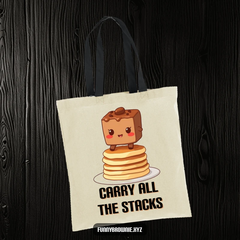 Funny tote bag showcasing a brownie character grinning while balancing on a stack of wobbly pancakes, perfect for carrying breakfast joy.