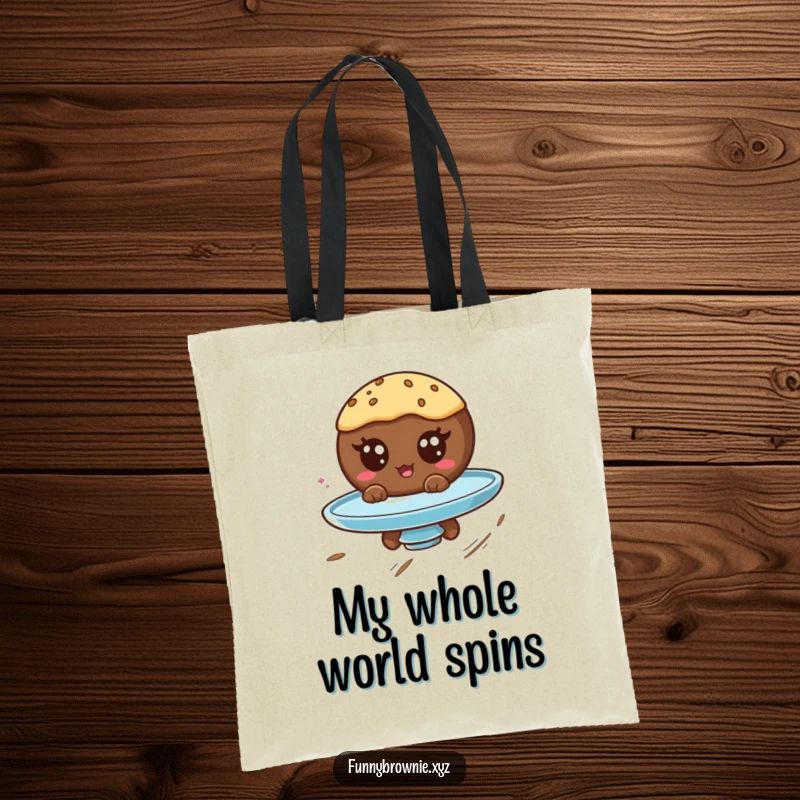 Funny tote bag showcasing a round brownie character with googly eyes spinning on a plate, perfect for carrying humor.